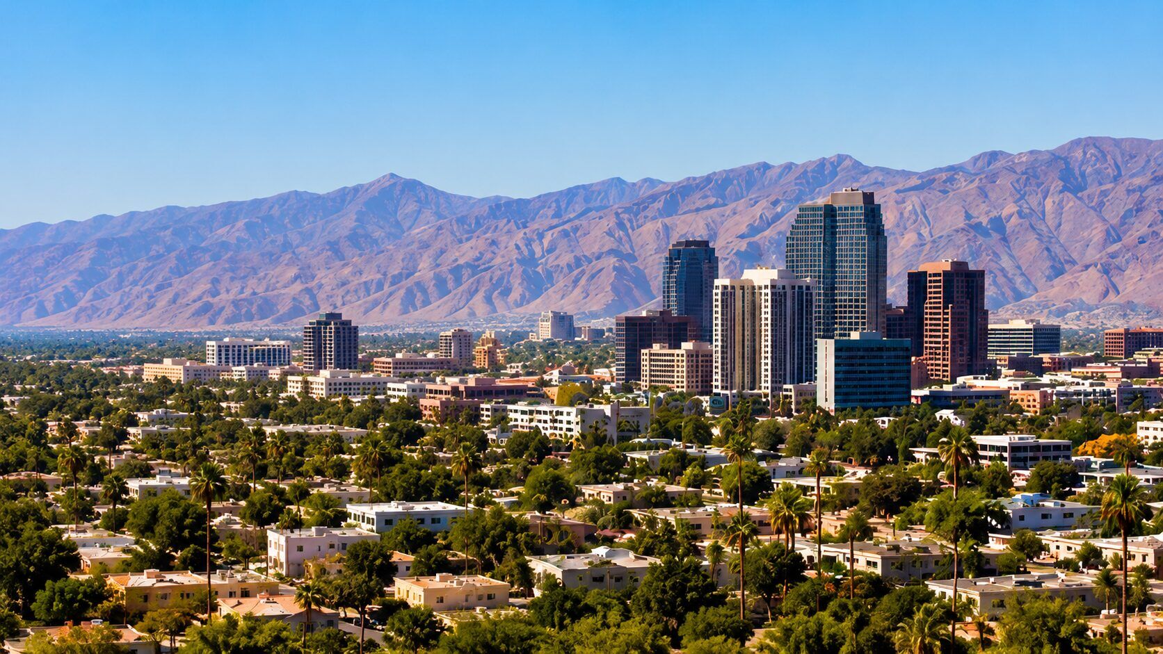 Downtown Phoenix skyline with desert mountains behind it